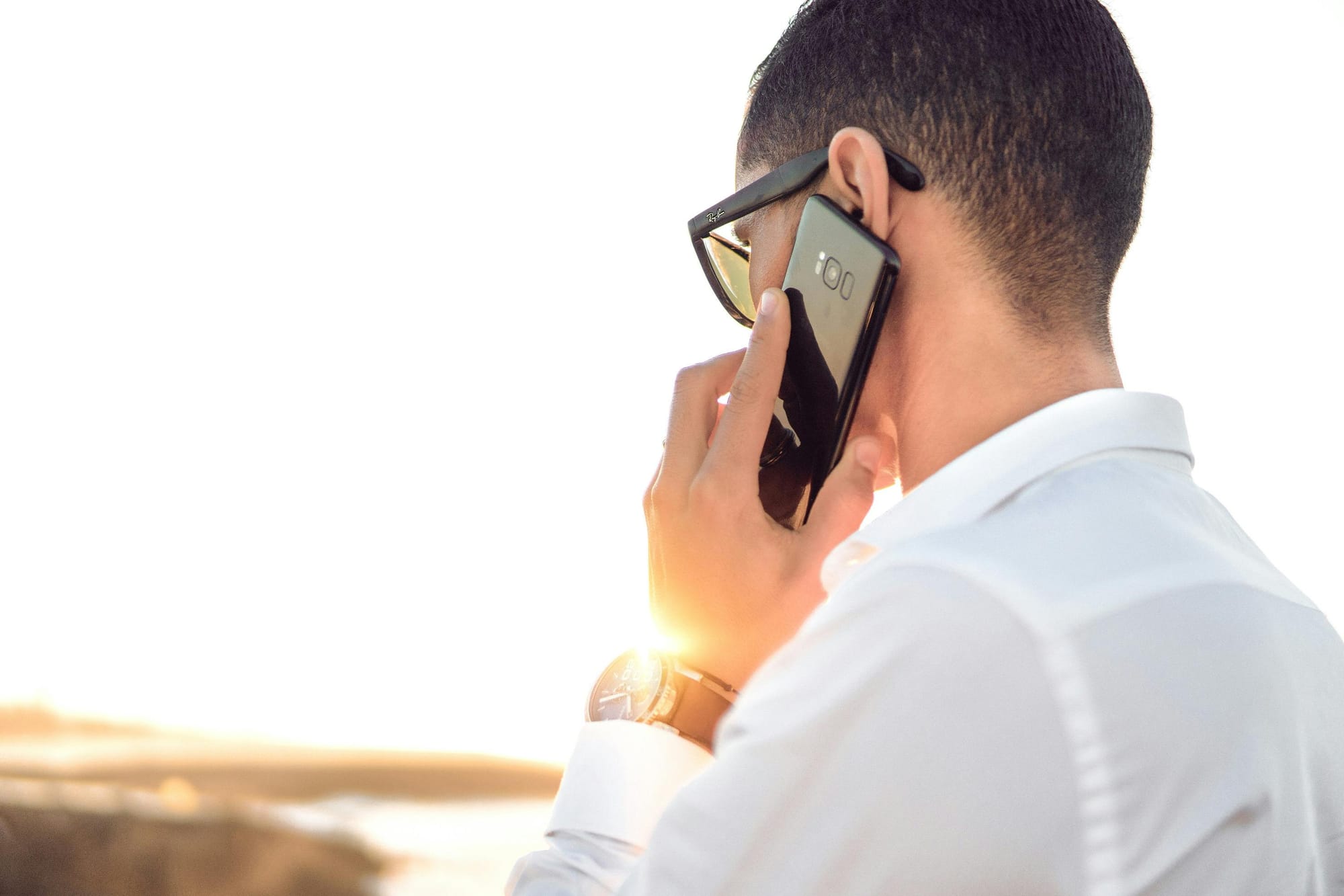Man looking into the horizon and making a call