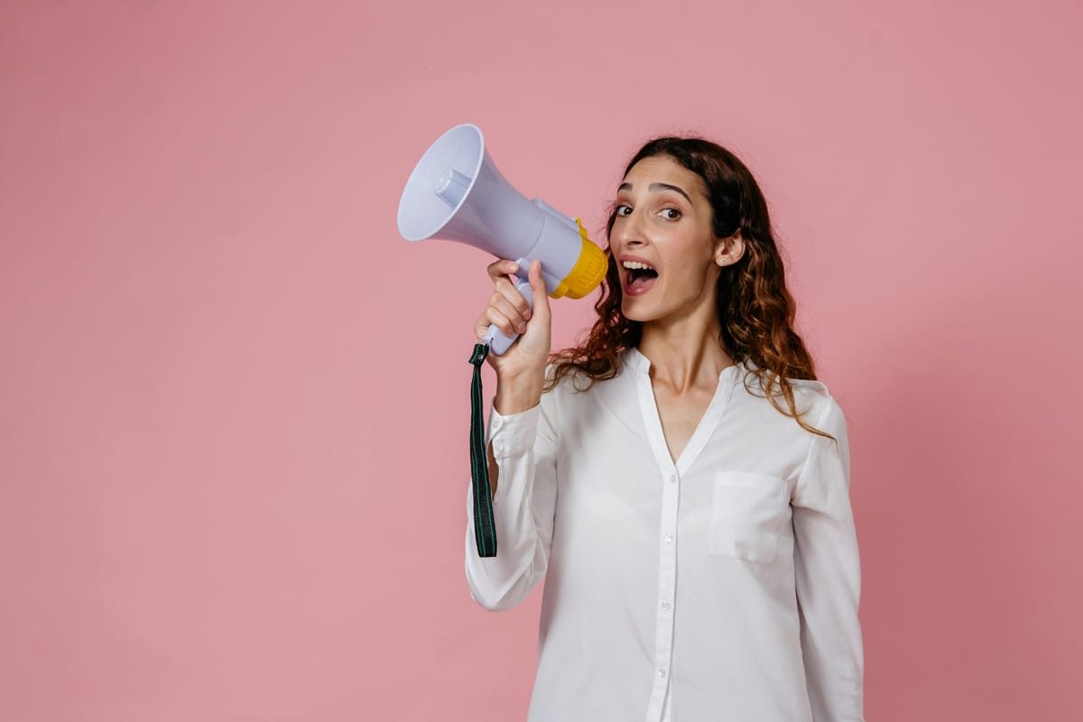 Woman holding broadcast mike and speaking on it